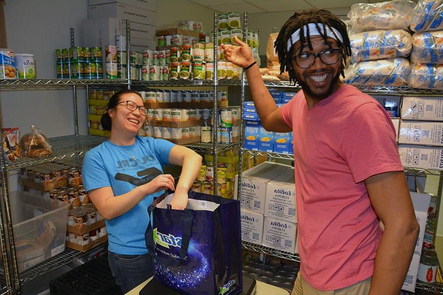 Two student work at Food Pantry U-Access.